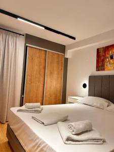 a bedroom with two beds with towels on them at Quince city center 3 in Heraklio