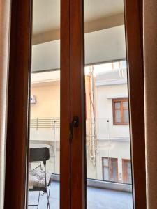 an open door with a view of a balcony at Quince city center 3 in Heraklio