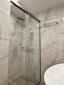a shower with a glass door in a bathroom at Quince city center 3 in Heraklio +72 photos