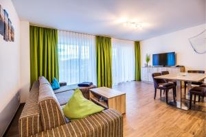 a living room with a couch and a table at Lagovida Das Ferienresort Am Störmthaler See in Großpösna