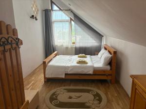 a small bedroom with a bed and a window at Venus - Apartamente de închiriat in Buşteni +48 photos