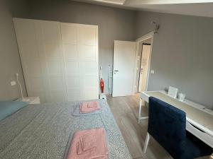 a bedroom with a bed and a table and a door at Splendida mansarda nel cuore della città in Turin