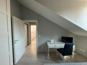 a room with a desk and a chair and a staircase at Splendida mansarda nel cuore della città in Turin