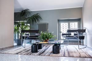 a living room with two chairs and a table at Hotel Duomo Cremona in Cremona