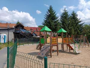 a playground with a slide in a park at Apartament Mazury in Ryn