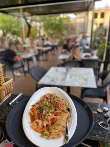 a plate of pasta on a table in a restaurant at Zace Studios in Ksamil