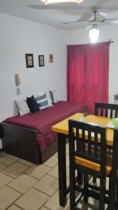 a bedroom with a bed and a table and chairs at Altos Mendoza Av España in Mendoza +13 photos
