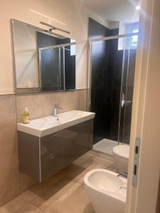 a bathroom with a sink and a toilet and a shower at San Pietro Pontremoli in Pontremoli