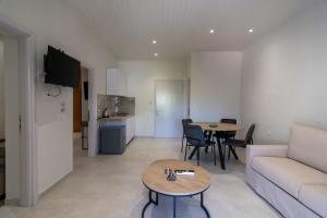 a living room with a couch and a table at Perdika's Nest in Perdika