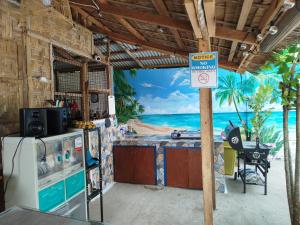 a kitchen with a view of the beach at La'Cris Homestay in Ocoy