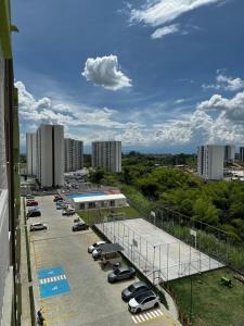 a parking lot with cars parked in a parking lot at Moderno apartamento con balcon y vista al guadual, Piscina y parqueadero in Pereira
