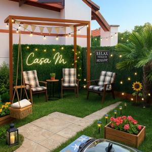 a garden with two chairs and a gazebo at Casa M in Kranevo