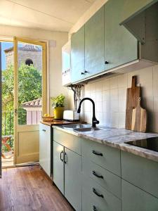 a kitchen with a sink and a counter top at Casa Margarita - céntrico y con vistas in Sant Joan de les Abadesses