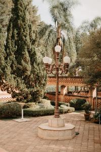 a street light in a courtyard with trees at Haras Buona Fortuna in Cotia +12 photos