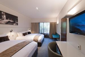 Letto o letti in una camera di Scenic Hotel Franz Josef Glacier