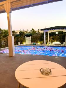 einen Tisch vor einem Pool in der Unterkunft Crystal Pool Villa Bay of Lalzi in Draç