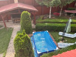 a garden with a swimming pool and a gazebo at Venus - Apartamente de închiriat in Buşteni