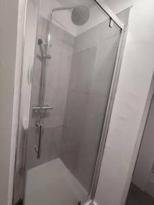 a shower with a glass door in a bathroom at En-Suite Double-Bedroom in the Heart of Salford Manchester CR1 Perfect for Short Stays in Manchester