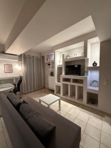 a living room with a couch and a tv at VillaGer in Kalamata