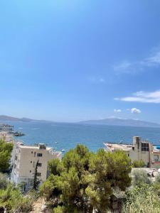 a view of the ocean from a city at Saranda Apartment in Polisi i Vogël