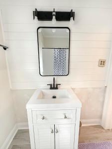 a bathroom with a white sink and a mirror at Beachside Walk & Casino Retreat - Breakfast - Hot Tub - Game Room in Gulfport +26 photos