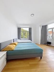 a bedroom with a large bed and a window at City Brussels 5 in Brussels