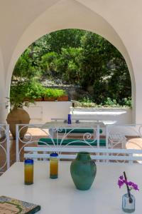 a table with a vase on top of a table at Il Carrubo Capri in Anacapri