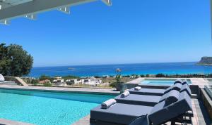 a villa with a pool and a view of the ocean at Solis Lindos Villa in Lindos