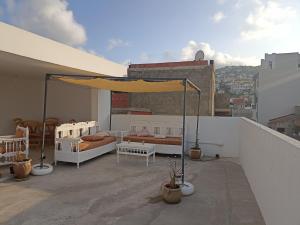 a balcony with two beds on a roof at Le nid cosy in Tabarka