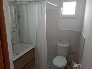a bathroom with a toilet and a sink and a shower at Le nid cosy in Tabarka