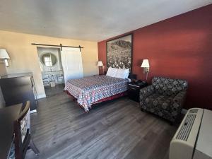 a hotel room with a bed and a chair at Motel 6 Pasadena, CA Old Town Pasadena Area in Pasadena