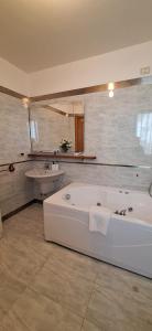 a large bathroom with a tub and a sink at Villa Giava in Francavilla al Mare +12 photos
