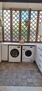 a kitchen with two washing machines and a window at Villa Giava in Francavilla al Mare