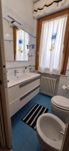 a bathroom with a sink and a toilet and a mirror at Villa Giava in Francavilla al Mare