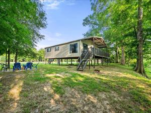 a tiny house in the woods with a slide at Floatin Daze in Wright City