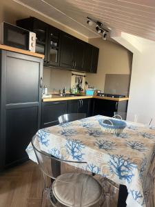 a kitchen with a table and a kitchen with black cabinets at Casa Lanza in Chioggia