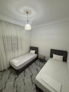Ένα ή περισσότερα κρεβάτια σε δωμάτιο στο Appartement climatisé à TABARKA 1