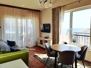 a living room with a couch and a table at Lux M & A Apartments in Budva