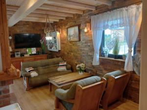 a living room with a couch and a table at Słoneczne Sople in Sople