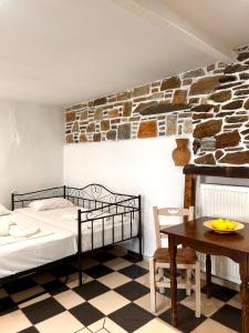 a bedroom with a bed and a table at Jasmine of Cyclades in Kinion