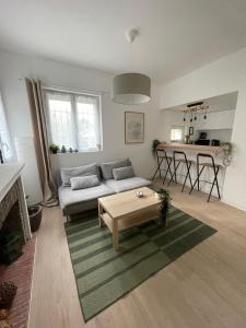 Proche Rouen - Magnifique T4 - 3 chambres في Déville-lès-Rouen: غرفة معيشة بها أريكة وطاولة +35 صورة