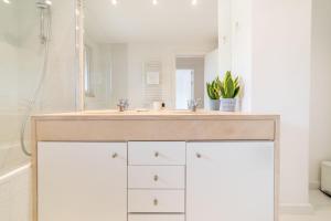 a bathroom with a sink and a mirror at Apartment Aroeira Golf II in Carcereiro +23 photos