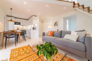 a living room with a gray couch and a table at Apartment Aroeira Golf II in Carcereiro