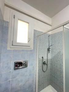 a bathroom with a shower with a window at Egidio's House Casa Vacanze Portixeddu in Portixeddu +38 photos