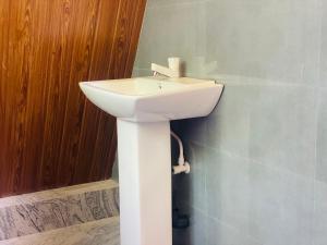 a white sink in the corner of a bathroom at Wild Eagle Safari Resort in Udawalawe +51 photos