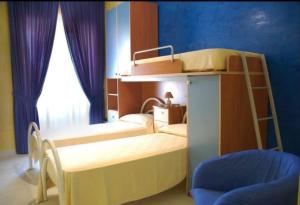 a bedroom with two bunk beds with a ladder at B&B Fresia in Ascea