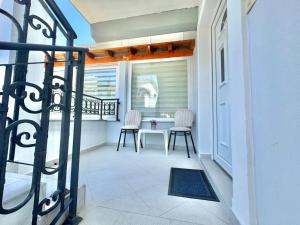 a balcony with two chairs and a table on a porch at Apartments Janda Bijela in Bijela