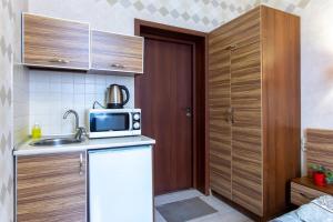 a small kitchen with a sink and a microwave at Sumska 45 in Kharkiv +17 photos