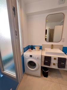 a bathroom with a washing machine and a sink at Le Patio in La Ciotat +29 photos