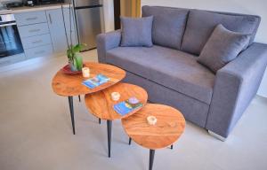 a living room with two tables and a couch at Kythira echoes stay - Lithari in Kythira
